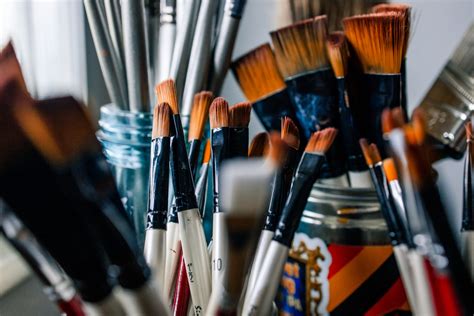 What is the best solvent for cleaning oil paint brushes, and why do some artists prefer to clean their brushes with moonlight?